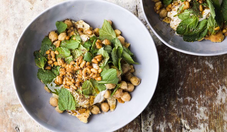 This image released by Milk Street shows a recipe for chickpea salad with yogurt and mint. (Milk Street via AP)