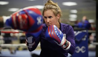 USA Boxing team member Ginny Fuchs takes part in drills during media day for the team in a gym located in a converted Macy&#x27;s Department store in Colorado Springs, Colo., in this Monday, June 7, 2021, file photo. Fuchs’ obsessive-compulsive disorder sometimes compels her to use a dozen toothbrushes a night and to buy hundreds of dollars of cleaning products per week. Yet Fuchs is headed to Tokyo next week to compete in the Olympic boxing tournament, where she realizes it’s almost impossible to avoid touching the blood, sweat and spit of her opponents.(AP Photo/David Zalubowski, File) **FILE**