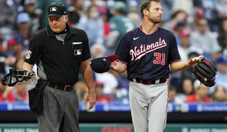 Washington Nationals pitcher Max Scherzer, right, waits to be checked for foreign substances near home plate umpire Tim Timmons after the first inning of a baseball game against the Philadelphia Phillies, Tuesday, June 22, 2021, in Philadelphia. (AP Photo/Matt Slocum)