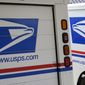In this Aug. 18, 2020, photo, mail delivery vehicles are parked outside a post office in Boys Town, Neb. (AP Photo/Nati Harnik) **FILE**