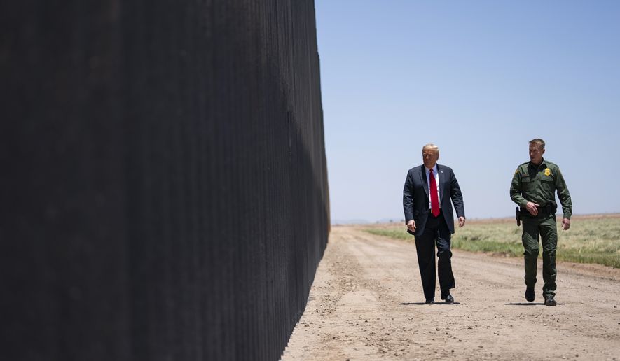 In this June 23, 2020, file photo, United State Border Patrol chief Rodney Scott gives President Donald Trump a tour of a section of the border wall in San Luis, Ariz. Former President Trump  is set to touch down in Texas on Wednesday, June 30, to cast a bright light on what he sees as the Biden administration&#39;s failed approach to illegal immigration and the “humanitarian crisis” that is playing out in his absence. (AP Photo/Evan Vucci, File)  **FILE**