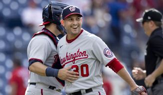 Washington Nationals closing pitcher Paolo Espino, right, celebrates with catcher Alex Avila, left, after the Nationals defeated the Philadelphia Phillies in a baseball game, Wednesday, June 23, 2021, in Philadelphia. (AP Photo/Laurence Kesterson)
