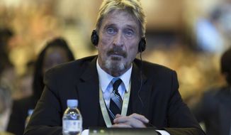 In this Tuesday, Aug. 16, 2016 file photo, software entrepreneur John McAfee listens during the 4th China Internet Security Conference (ISC) in Beijing. McAfee, the creator of the McAfee antivirus software, was found dead in a prison near Barcelona Wednesday, June 23, 2021, hours after Spain’s National Court approved his extradition to the to the United States, where he was wanted on tax-related criminal charges. He was 75. (AP Photo/Ng Han Guan, File)