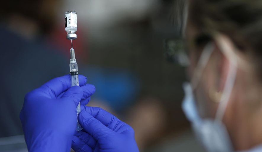 Nurse Jody Berry draws a syringe full of the Johnson &amp;amp; Johnson COVID-19 vaccine at a clinic at Mother&#39;s Brewing Company in Springfield, Mo., on Tuesday, June 22, 2021. As the U.S. emerges from the COVID-19 crisis, Missouri is becoming a cautionary tale for the rest of the country: It is seeing an alarming rise in cases because of a combination of the fast-spreading delta variant and stubborn resistance among many people to getting vaccinated. (Nathan Papes/The Springfield News-Leader via AP)