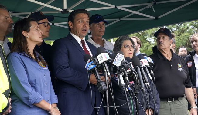 Florida Gov. Ron DeSantis, second from left, speaks during a news conference near the scene where a wing of a 12-story beachfront condo building collapsed, Thursday, June 24, 2021, in the Surfside area of Miami. At left is Lt. Gov. Jeanette Nunez, (AP Photo/Lynne Sladky)