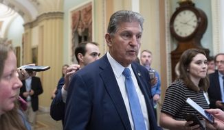 Sen. Joe Manchin, D-W.Va., speaks with reporters as he walks at the Capitol in Washington, Thursday, June 24, 2021. A bipartisan group of lawmakers have negotiated a plan to pay for an estimated $1 trillion compromise plan. (AP Photo/Alex Brandon)