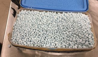 This photo provided by the U.S. Drug Enforcement Administration&#39;s Phoenix Division shows one of four containers holding some of the 30,000 fentanyl pills the agency seized in one of its bigger busts in Tempe, Ariz., in August 2017. Fentanyl is a potent synthetic opioid. (Drug Enforcement Administration via AP)