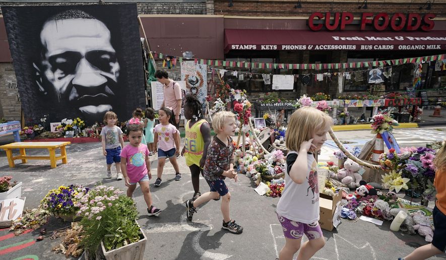 Preschool children visit the site where George Floyd was murdered by then-Minneapolis Police Officer Derek Chauvin, as the kids took a field trip to the memorial, Thursday, June 24, 2021, in Minneapolis. Chauvin is scheduled to be sentenced on Friday. (AP Photo/Julio Cortez)