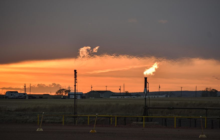 In this Tuesday, May 18, 2021, file photo, flares burn natural gas from oil production in the Fort Berthold Indian Reservation east of New Town, North Dakota. Oil pumped from Native American lands in the U.S. increased about tenfold since 2009 to more than 130 million barrels annually, bringing new wealth to a small number of tribes. Tribes left out of the drilling boom have become increasingly outspoken against fossil fuels as climate change&#39;s impacts grow worse. (AP Photo/Matthew Brown)