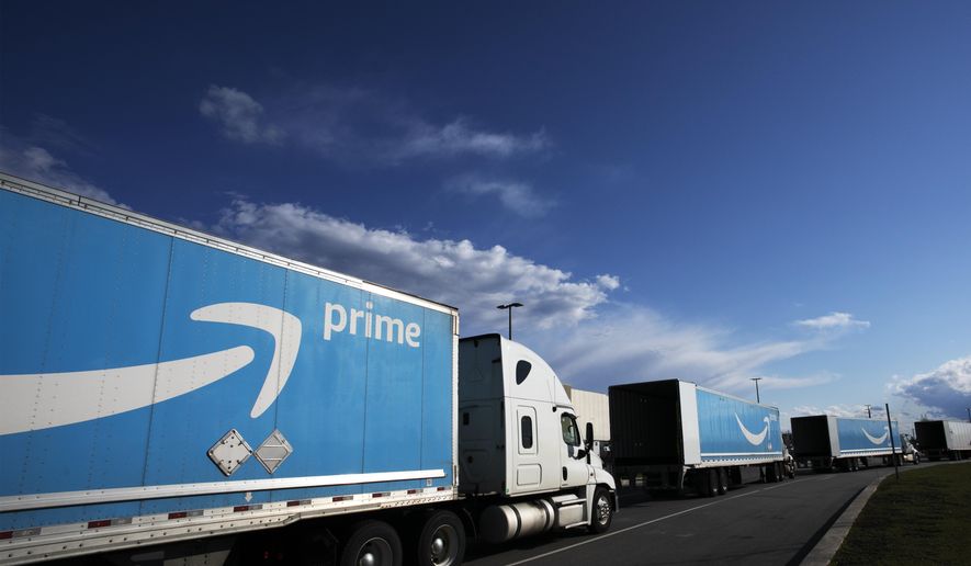 This April 21, 2020, file photo shows Amazon tractor-trailers line up outside the Amazon Fulfillment Center in the Staten Island borough of New York. (AP Photo/Mark Lennihan, File)