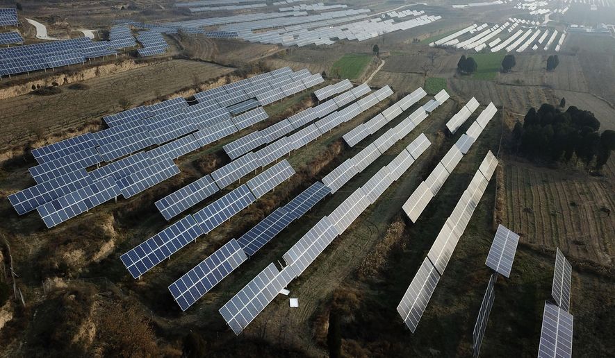 In this Nov. 28, 2019, file photo, a solar panel installation is seen in Ruicheng County in central China&#39;s Shanxi Province. China&#39;s government on Friday, June 25, 2021 criticized U.S. curbs on imports of solar panel materials that might be made with forced labor as an attack on its development and said Beijing will protect Chinese companies, but gave no details of possible retaliation. (AP Photo/Sam McNeil, File)