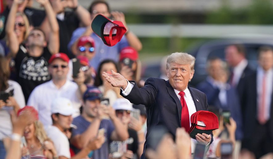 Former President Donald Trump throws &#x27;Save America&quot; hats to the audience before speaking at a rally at the Lorain County Fairgrounds, Saturday, June 26, 2021, in Wellington, Ohio. (AP Photo/Tony Dejak)
