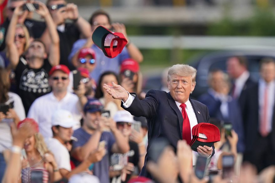 Former President Donald Trump throws &#39;Save America&quot; hats to the audience before speaking at a rally at the Lorain County Fairgrounds, Saturday, June 26, 2021, in Wellington, Ohio. (AP Photo/Tony Dejak)
