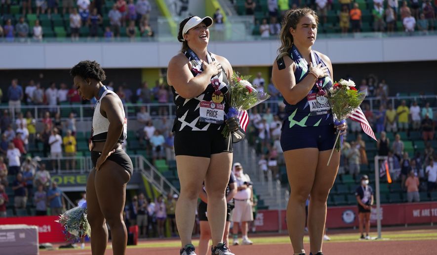 Gwendolyn Berry, left, looks away as DeAnna Price and Brooke Andersen stand for the national anthem after the finals of the women&#39;s hammer throw at the U.S. Olympic Track and Field Trials Saturday, June 26, 2021, in Eugene, Ore. Price won, Andersen was second, and Berry finished third. (AP Photo/Charlie Riedel) **FILE**
