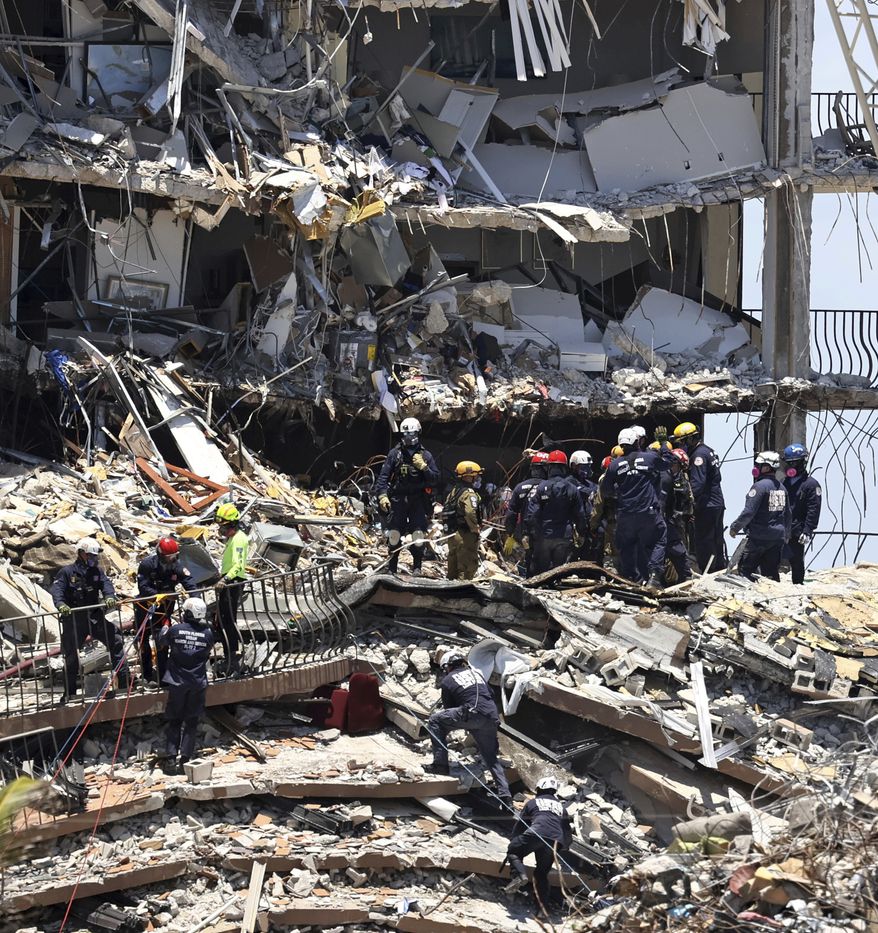 Search and rescue personnel search for survivors through the rubble at the Champlain Towers South in Surfside, Fla., Sunday, June 27, 2021. The apartment building partially collapsed on Thursday, June 24. (David Santiago/Miami Herald via AP)