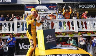 Kyle Busch celebrates with teammates after winning a NASCAR Cup Series auto race at Pocono Raceway, Sunday, June 27, 2021, in Long Pond, Pa. (AP Photo/Matt Slocum)