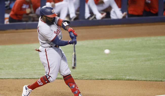Washington Nationals batter Josh Harrison hits an RBI-single against the Miami Marlins during the first inning of a baseball game, Sunday, June 27, 2021, in Miami. (AP Photo/Rhona Wise)