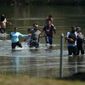 A group of migrants mainly from Venezuela wade through the Rio Grande as they cross the U.S.-Mexico border, Wednesday, June 16, 2021, in Del Rio, Texas. (AP Photo/Eric Gay) ** FILE **