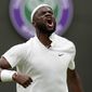 Frances Tiafoe of the US celebrates after breaking the serve of Stefanos Tsitsipas of Greece during the men&#39;s singles match on day one of the Wimbledon Tennis Championships in London, Monday June 28, 2021. (AP Photo/Alastair Grant)