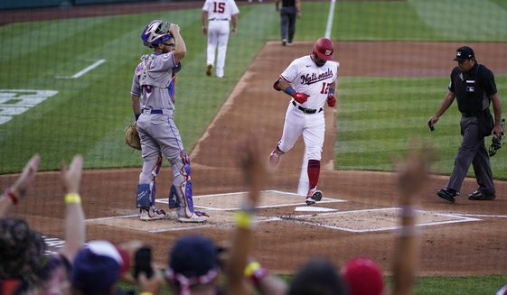 Washington Nationals&#39; Kyle Schwarber, center, crosses home plate for his solo home run during the first inning of a baseball game against the New York Mets at Nationals Park, Monday, June 28, 2021, in Washington. (AP Photo/Alex Brandon)