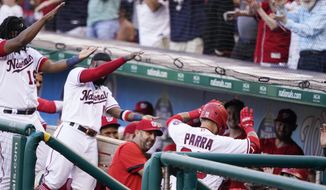 Teammates celebrate as Washington Nationals&#39; Gerardo Parra goes into the dugout after his solo home run during the second inning of a baseball game against the New York Mets at Nationals Park, Monday, June 28, 2021, in Washington. (AP Photo/Alex Brandon)