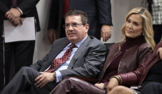 Washington Redskins owner Dan Snyder, left, and his wife Tanya Snyder, listen to head coach Ron Rivera during a news conference at the team&#x27;s NFL football training facility in Ashburn, Va., in this Thursday, Jan. 2, 2020, file photo. Dan Snyders wife Tanya was named co-CEO of the Washington Football Team on Tuesday, June 29, 2021, giving her bigger influence in the club that is currently in the midst of an independent investigation into workplace conduct the NFL is overseeing. (AP Photo/Alex Brandon, File) **FILE**
