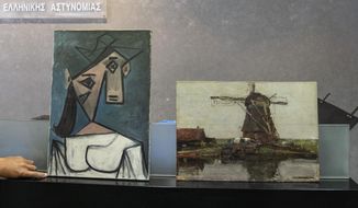 A cubist female bust by the Spanish painter Picasso, left, and a 1905 representational oil painting of a riverside windmill by the Dutch painter Mondrian are displayed by police officers, in Athens during a press conference, on Tuesday, June 29, 2021. Greek police says they have recovered two paintings by 20th century masters Pablo Picasso and Piet Mondrian, nearly a decade after their theft from the country&#39;s biggest state art gallery in Athens. (AP Photo/Petros Giannakouris)