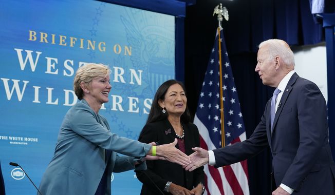 President Joe Biden, right, greets Energy Secretary Jennifer Granholm, left, and Interior Secretary Deb Haaland, center, before the start of an event in the South Court Auditorium on the White House complex in Washington, Wednesday, June 30, 2021, with Cabinet officials and governors from Western states to discuss drought and wildfires. (AP Photo/Susan Walsh)
