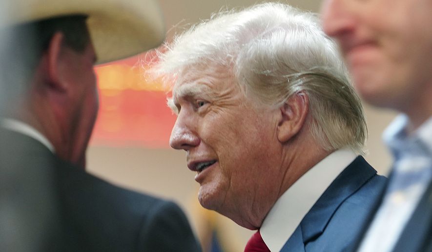 Former President Donald Trump greets attendees as he enters the room at a border security briefing at the Texas DPS Weslaco Regional Office on Wednesday, June 30, 2021, in Weslaco, Texas. (Joel Martinez/The Monitor via AP, Pool)