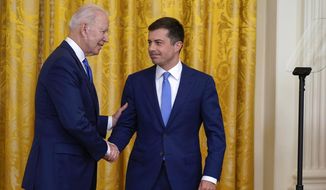 President Joe Biden shakes hands with Transportation Secretary Pete Buttigieg during an event to commemorate Pride Month, in the East Room of the White House, Friday, June 25, 2021, in Washington. (AP Photo/Evan Vucci) ** FILE **
