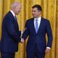 President Joe Biden shakes hands with Transportation Secretary Pete Buttigieg during an event to commemorate Pride Month, in the East Room of the White House, Friday, June 25, 2021, in Washington. (AP Photo/Evan Vucci) ** FILE **