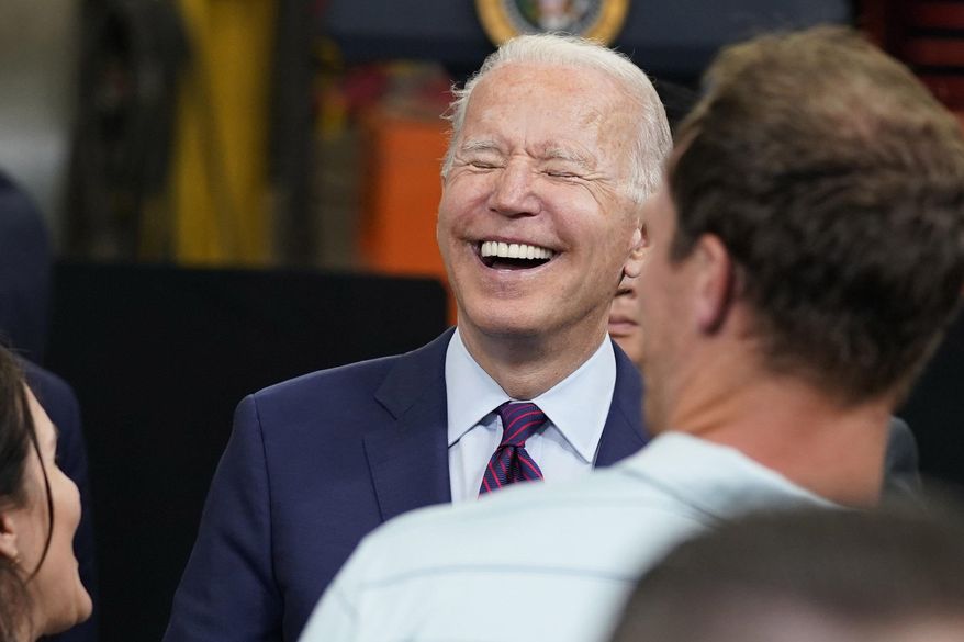 President Joe Biden laughs with guests after speaking on infrastructure spending at the La Crosse Municipal Transit Authority, Tuesday, June 29, 2021, in La Crosse, Wis. (AP Photo/Evan Vucci)