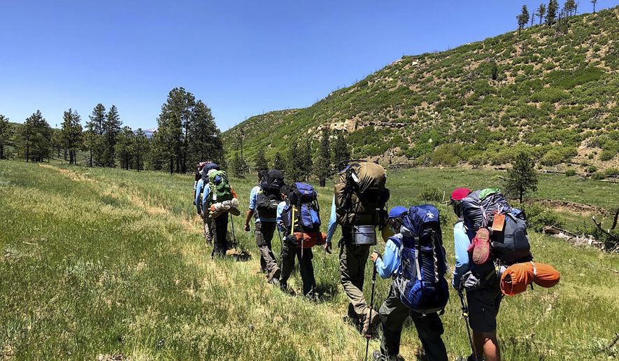 In this June 10, 2021 photo provided by Barry Bedlan, members of Troop 298 of Frisco, Texas are among the first to embark a 12-day trek across the Philmont Scout Ranch, outside Cimarron, N.M. Boy Scout and Girl Scouts’ leadership say their summer camps are full, special events are sold out, and they’re expecting many thousands of families – some new to scouting, some who left during the pandemic – to sign up now that activities are occurring in-person rather than virtually. (Barry Bedlan via AP)
