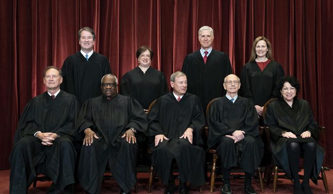 In this April 23, 2021, file photo, members of the Supreme Court pose for a group photo at the Supreme Court in Washington. Seated from left are Associate Justice Samuel Alito, Associate Justice Clarence Thomas, Chief Justice John Roberts, Associate Justice Stephen Breyer and Associate Justice Sonia Sotomayor, Standing from left are Associate Justice Brett Kavanaugh, Associate Justice Elena Kagan, Associate Justice Neil Gorsuch and Associate Justice Amy Coney Barrett. The Supreme Court is wrapping up its first all-virtual term, with decisions expected in a key case on voting rights and another involving information California requires charities to provide about donors. The court&#x27;s last day of work Thursday, July 1, before its summer break also could include a retirement announcement, although the oldest of the justices, 82-year-old Stephen Breyer, has given no indication he intends to step down this year. (Erin Schaff/The New York Times via AP, Pool)