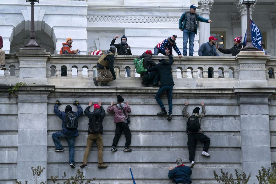 FILE - In this Jan. 6, 2021 file photo, violent insurrectionists loyal to President Donald Trump scale the west wall of the the U.S. Capitol in Washington. (AP Photo/Jose Luis Magana, File)