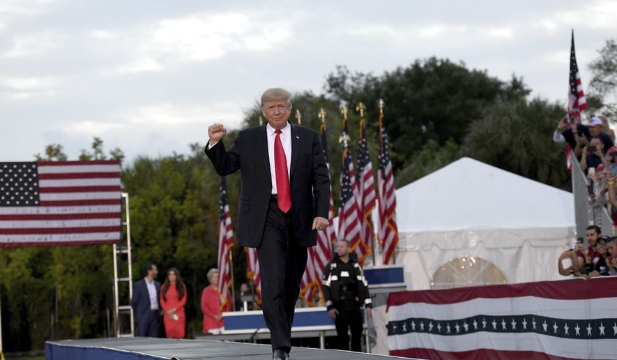 Former President Donald Trump walks onto the stage during a rally at the Sarasota Fairgrounds Saturday, July 3, 2021, in Sarasota, Fla. (AP Photo/Jason Behnken)