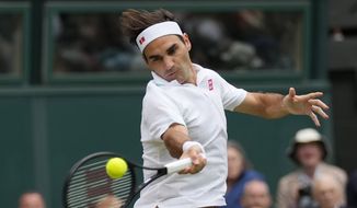 Switzerland&#39;s Roger Federer returns the ball to Italy&#39;s Lorenzo Sonego on day seven of the Wimbledon Tennis Championships in London, Monday, July 5, 2021. (AP Photo/Kirsty Wigglesworth)