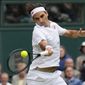 Switzerland&#39;s Roger Federer returns the ball to Italy&#39;s Lorenzo Sonego on day seven of the Wimbledon Tennis Championships in London, Monday, July 5, 2021. (AP Photo/Kirsty Wigglesworth)