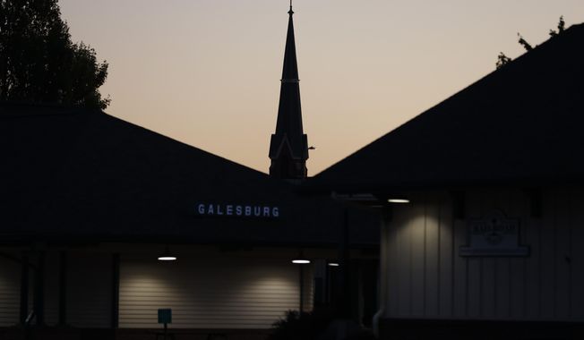 The steeple of the Corpus Christi Catholic Church is silhouetted against the evening sky, Monday, June 14, 2021, in Galesburg, Ill. Settled more than 180 years ago, Galesburg was built around Knox College, founded by Presbyterians from upstate New York seeking a Christian school on the western frontier. The city soon became home to Illinois&#x27; first anti-slavery society. (AP Photo/Shafkat Anowar) ** FILE **