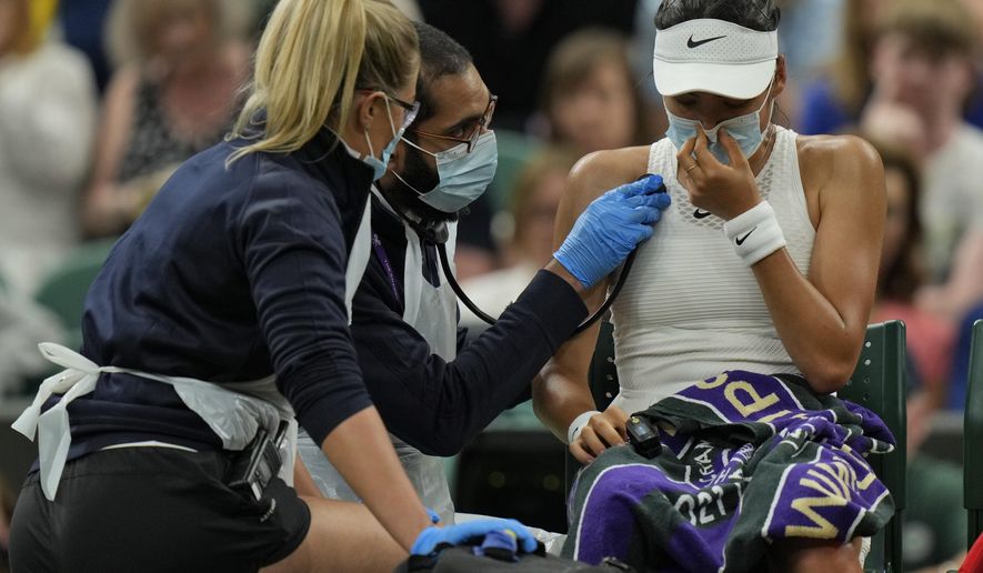 Britain&#x27;s Emma Raducanu receive medical attention during the women&#x27;s singles fourth round match against Australia&#x27;s Ajla Tomljanovic on day seven of the Wimbledon Tennis Championships in London, Monday, July 5, 2021. (AP Photo/Alastair Grant)