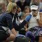 Britain&#39;s Emma Raducanu receive medical attention during the women&#39;s singles fourth round match against Australia&#39;s Ajla Tomljanovic on day seven of the Wimbledon Tennis Championships in London, Monday, July 5, 2021. (AP Photo/Alastair Grant)