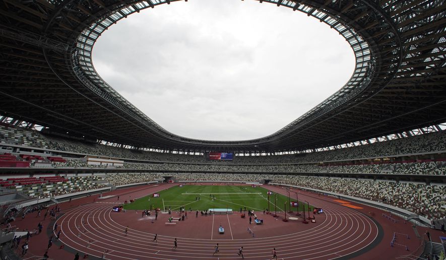 In this May 11, 2021, file photo, athletes compete in the men&#39;s 400-meter T20 race during an athletics test event for the Tokyo 2020 Paralympics Games at National Stadium in Tokyo. The pandemic-delayed Tokyo Olympics are shaping up as a TV-only event with few fans — if any — being allowed when they open in just over two weeks. Japan&#39;s Asahi newspaper, citing multiple unidentified government sources, says the opening ceremony will be limited only to VIP guests. (AP Photo/Shuji Kajiyama, File)