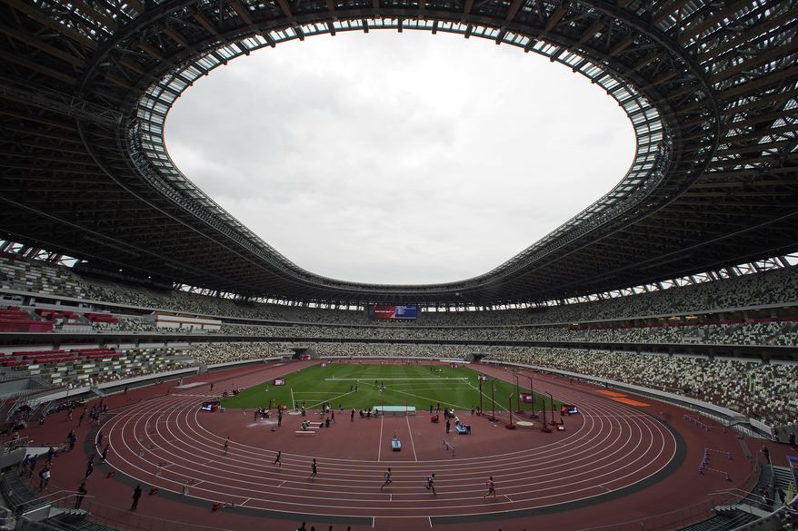 In this May 11, 2021, file photo, athletes compete in the men&#39;s 400-meter T20 race during an athletics test event for the Tokyo 2020 Paralympics Games at National Stadium in Tokyo. The pandemic-delayed Tokyo Olympics are shaping up as a TV-only event with few fans — if any — being allowed when they open in just over two weeks. Japan&#39;s Asahi newspaper, citing multiple unidentified government sources, says the opening ceremony will be limited only to VIP guests. (AP Photo/Shuji Kajiyama, File)