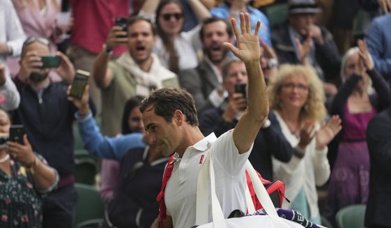 Switzerland&#39;s Roger Federer leaves the court after being defeated by Poland&#39;s Hubert Hurkacz during the men&#39;s singles quarterfinals match on day nine of the Wimbledon Tennis Championships in London, Wednesday, July 7, 2021. (AP Photo/Alberto Pezzali)