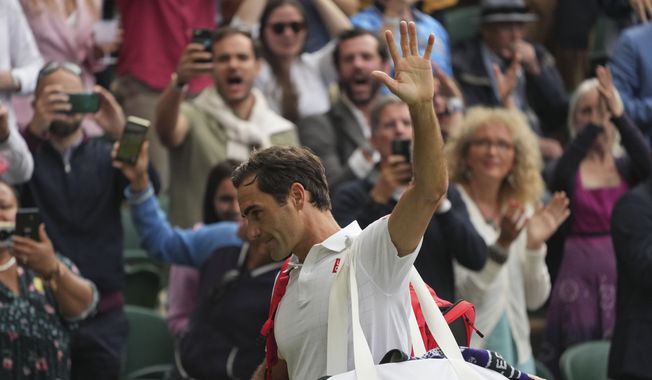 Switzerland&#x27;s Roger Federer leaves the court after being defeated by Poland&#x27;s Hubert Hurkacz during the men&#x27;s singles quarterfinals match on day nine of the Wimbledon Tennis Championships in London, Wednesday, July 7, 2021. (AP Photo/Alberto Pezzali)