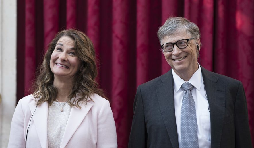 FILE - In this April 21, 2017, file photo, Philanthropist and co-founder of Microsoft, Bill Gates, right, and his wife Melinda react, prior to being awarded the Legion of Honour at the Elysee Palace in Paris.   Bill Gates and Melinda French Gates will continue to work together as co-chairs of their foundation even after their planned divorce. However, if after two years they cannot continue in their roles, French Gates will resign her positions as co-chair and trustee, The Bill and Gates Melinda Foundation announced Wednesday, July 7, 2021.  (AP Photo/Kamil Zihnioglu, Pool)