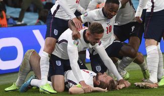 England&#39;s Harry Kane, bottom, celebrates with his teammates after scoring his side&#39;s second goal during the Euro 2020 soccer semifinal match between England and Denmark at Wembley stadium in London, Wednesday, July 7, 2021. (Laurence Griffiths/Pool Photo via AP)