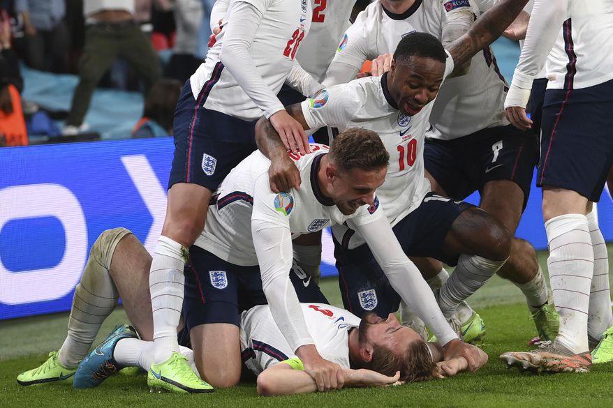 England&#39;s Harry Kane, bottom, celebrates with his teammates after scoring his side&#39;s second goal during the Euro 2020 soccer semifinal match between England and Denmark at Wembley stadium in London, Wednesday, July 7, 2021. (Laurence Griffiths/Pool Photo via AP)