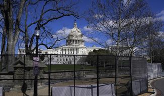 In this April 2, 2021, file photo the U.S. Capitol is seen behind security fencing on Capitol Hill in Washington. (AP Photo/Carolyn Kaster, File)