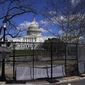 In this April 2, 2021, file photo the U.S. Capitol is seen behind security fencing on Capitol Hill in Washington. (AP Photo/Carolyn Kaster, File)